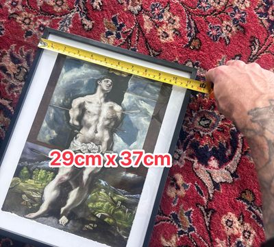 A framed art print of Saint Sebastian being measured by the author with a tape measure. The overlaid text shows that the image is 29 by 37 centimeters.